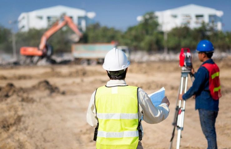 Civil engineer checking construction site for new construction